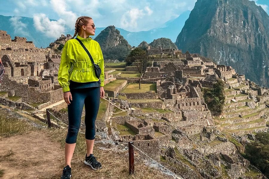 Tourist posing at Machu Picchu - inca trail to machu picchu