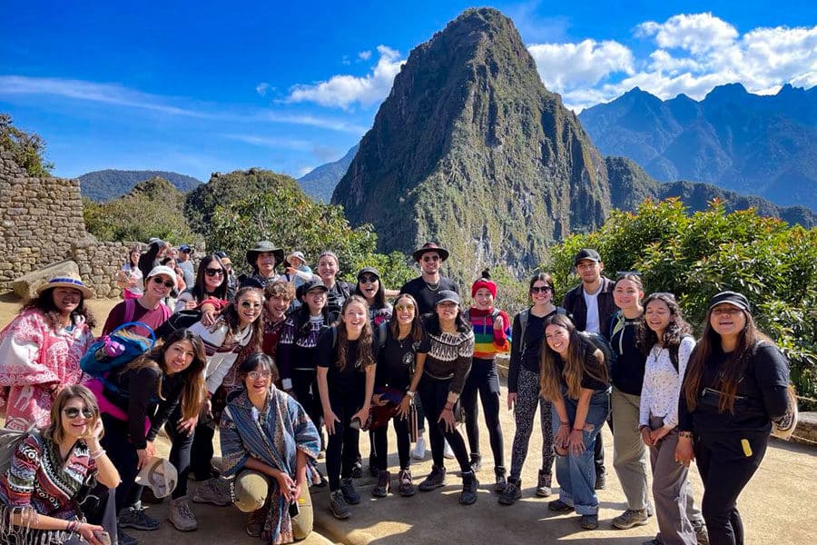 Group of travelers posing at Machu Picchu